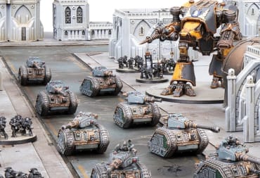 A war table featuring white gothic buildings, a giant mech in the background, groups of tanks patrolling down a road, and several units accompanying them.