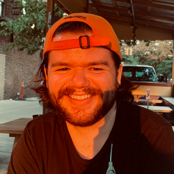 Christian Buckley, sitting in sunlight with dragonball hat on